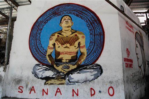 A mural depicting Venezuela's President Hugo Chavez and the words in Spanish "Healing" covers a wall along a downtown street in Caracas, Venezuela.