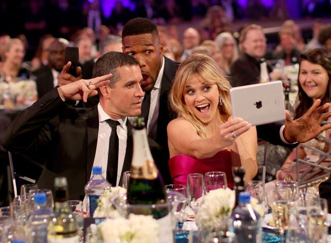 Jim Toth, host Michael Strahan and actress Reese Witherspoon pose for selfies
