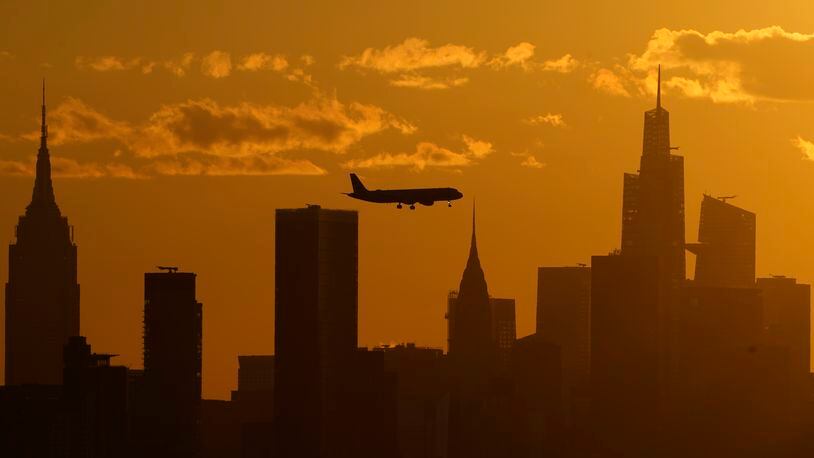 FILE - A plane flies with the New York City skyline, Thursday, Sept. 8, 2022, in New York. The ground rumbled Friday, April 5, 2024, beneath New York City, home to famous skyscrapers like the Empire State Building and One World Trade Center. Though buildings that can reach above 100 stories might seem especially vulnerable to earthquakes, engineering experts say they're built with enough flexibility to withstand them. (AP Photo/Julia Nikhinson, File)