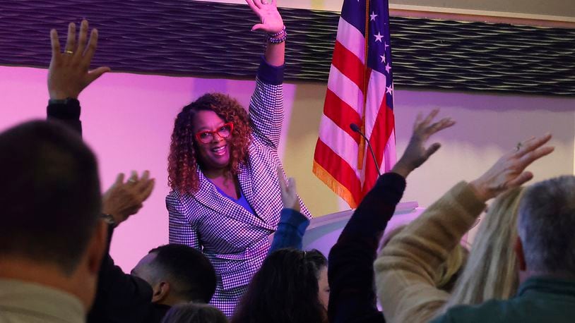 Terra Fox Williams, president and CEO of YWCA Dayton, encourages the crowd to stand up and stretch at the begining of her keynote speach at the annual Dr. Martin Luther King Luncheon Friday, Jan. 12, 2024 at the Hollenbeck Bayley Conference Center. BILL LACKEY/STAFF