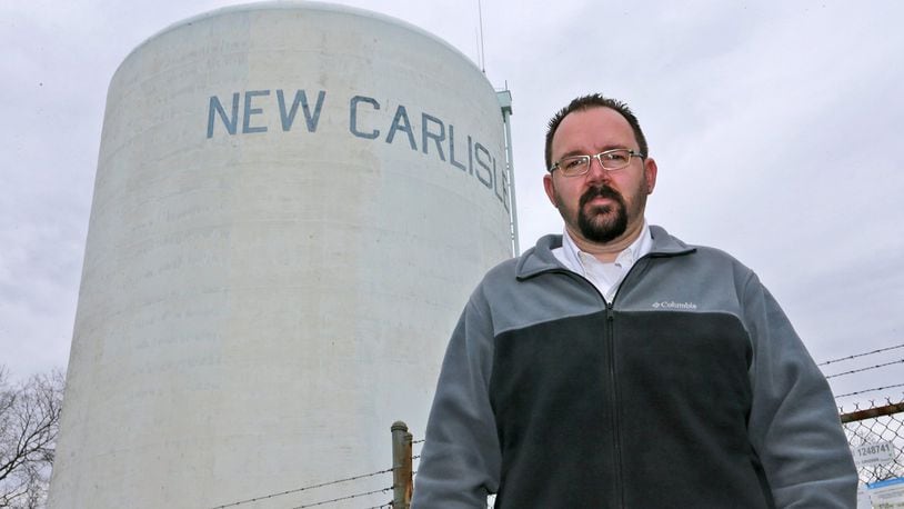 New Carlisle Mayor Mike Lowrey stands under the New Carlisle water tower in 2017. Bill Lackey/Staff