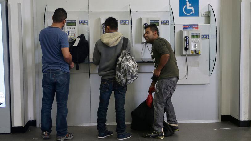 Mexican citizens use pay phones at the airport after being deported from the U.S., in Mexico City, Thursday, Feb. 23, 2017. While U.S. Homeland Security Secretary John Kelly and U.S. Secretary of State Rex Tillerson tried to alleviate Mexico's concerns during a visit to Mexico City, President Donald Trump was fanning them further with tough talk about "getting really bad dudes out of this country at a rate nobody has ever seen before." (AP Photo/Marco Ugarte)