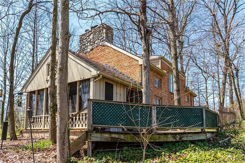 A 4-season room, wood deck with railing is in back. The home has a wooded lot with mature trees. CONTRIBUTED PHOTO