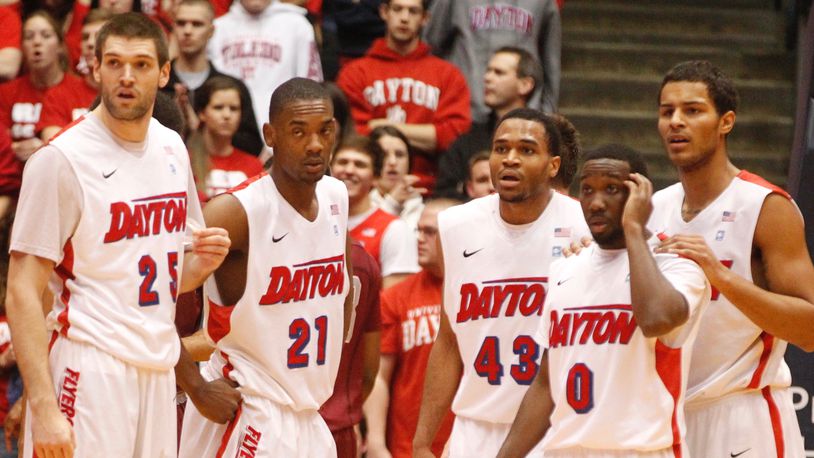 Dayton's Alex Gavrilovic, Dyshawn Pierre, Vee Sanford, Khari Price and Devin Oliver look to the bench for instruction during a game against Saint Joseph's on Wednesday, Jan. 29, 2014, at UD Arena. David Jablonski/Staff