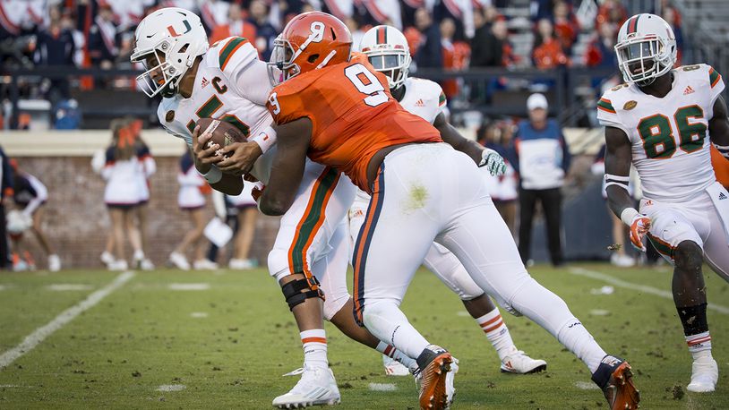 CHARLOTTESVILLE, VA - NOVEMBER 12: Brad Kaaya #15 of the Miami Hurricanes is sacked by Andrew Brown #9 of the Virginia Cavaliers during a game at Scott Stadium on November 12, 2016 in Charlottesville, Virginia. (Photo by Chet Strange/Getty Images)