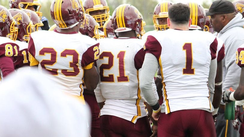 Trent Mays (1) huddles around the Central State offense during the spring game April 22. CSU head coach Cedric Pearl is at right. Photo courtesy of Central State University