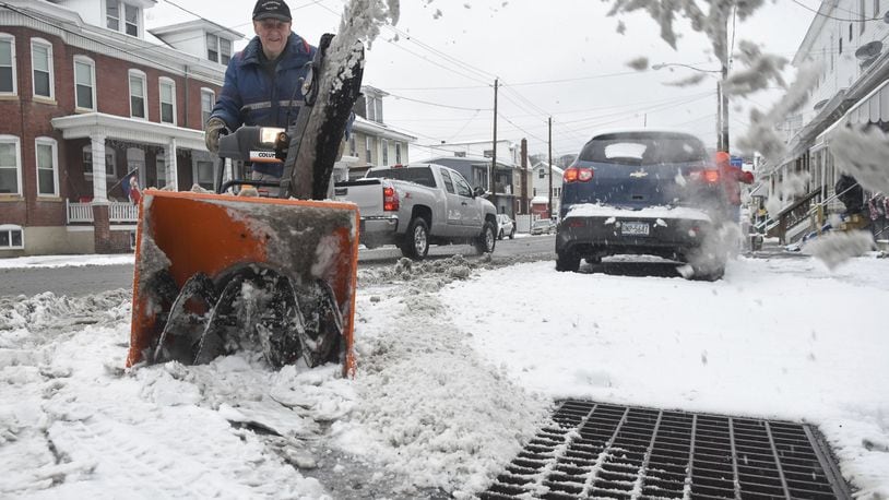 Lee Miller, Port Carbon, Pa., cuts through the snow on Coal Street in Port Carbon, Pa., on Thursday, Dec. 29, 2016. (Jacqueline Dormer/Republican-Herald via AP)
