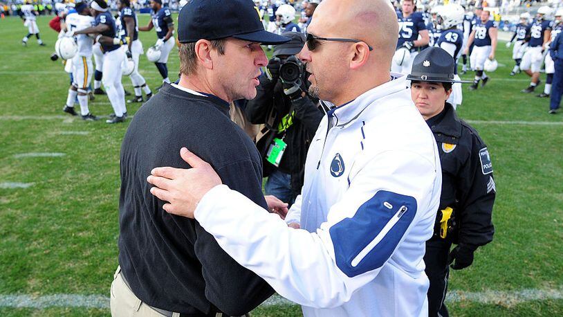 STATE COLLEGE, PA - NOVEMBER 21:  James Franklin head coach of the Penn State Nittany Lions congratulates Jim Harbaugh head coach of the Michigan Wolverines after the game at Beaver Stadium on November 21, 2015 in State College, Pennsylvania.  The Wolverines won 28-16. (Photo by Evan Habeeb/Getty Images)