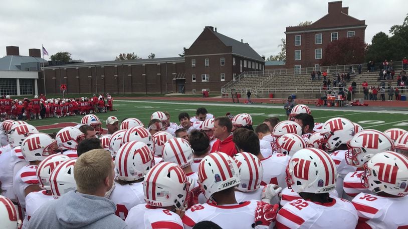 Wittenberg huddles around Joe Fincham after a victory at Wabash on Saturday, Oct. 28, 2017, in Crawfordsville, Ind.
