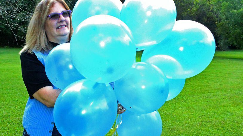 Carmela Wiant gets ready to release balloons to honor her son who was killed in an auto accident. Wiant helped get a state law passed to create a Next of Kin Registry. JEFF GUERINI/STAFF
