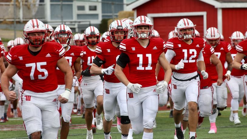 Wittenberg players, including Isaac Grilliot 
 (71) and Josh Collins (11), run onto the field before a game against DePauw on Saturday, Oct. 21, 2023, at Edwards-Maurer Field in Springfield. David Jablonski/Staff