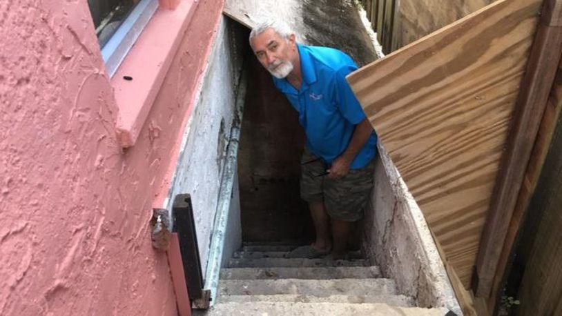 George Paddick descends the outside steps to the basement.