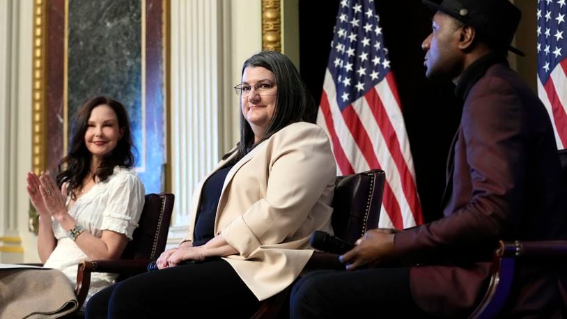 Shelby Rowe, center, Executive Director of the Suicide Prevention Research Center, flanked by Ashley Judd, left, and singer-songwriter Aloe Blacc, right, finishes speaking during an event on the White House complex in Washington, Tuesday, April 23, 2024, with notable suicide prevention advocates. The White House held the event on the day they released the 2024 National Strategy for Suicide Prevention to highlight efforts to tackle the mental health crisis and beat the overdose crisis. (AP Photo/Susan Walsh)