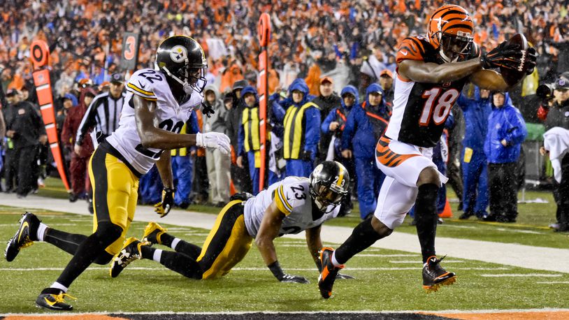 Cincinnati Bengals receiver AJ Green makes a catch and runs it in for a touchdown during their 18-16 loss to the Pittsburgh Steelers in the AFC wild card playoff game Saturday, Jan. 9 at Paul Brown Stadium in Cincinnati. NICK GRAHAM/STAFF