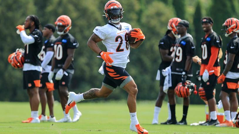 Cincinnati Bengals' Joe Mixon carries the ball during NFL football practice in Cincinnati, Wednesday, July 28, 2021. (AP Photo/Aaron Doster)