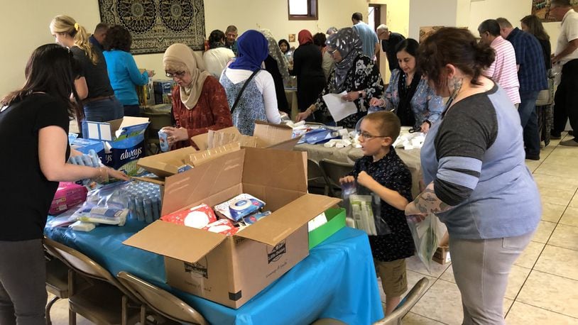 Members of the Muslim and Christian communities got together to create 500 packs of food and personal hygiene items to donate to the Springfield Soup Kitchen on Sunday, May 19. Photo by Brett Turner