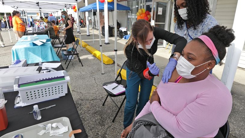 Dameka Cunigan gets the COVID vaccine shot during the second annual Community Health Fair at FamilyNeeds, Inc. Thursday. Health care organization and doctors were on hand to do health check and to educate residents about healthy living. BILL LACKEY/STAFF
