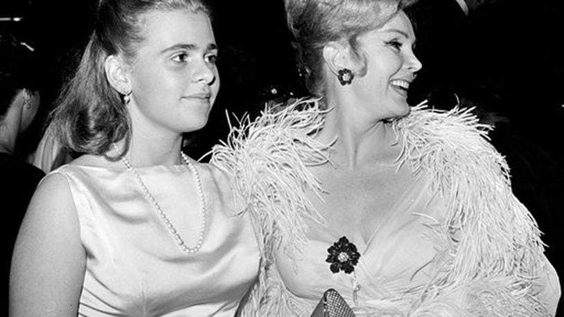 FILE-This June 20, 1963 file photo Zsa Zsa Gabor, right, and her 16-year-old daughter Francesca Hilton are seen arriving for a premiere in the Hollywood. Publicist Edward Lozzi says Hilton died Monday, Jan. 5, 2015 at Cedars-Sinai Medical Center after an apparent heart attack and stroke. She was 67. (AP Photo/Harold P. Matosian, File)