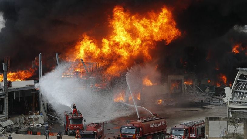 Fire burns in the port in Beirut, Lebanon, Thursday, Sept. 10. 2020. A huge fire broke out Thursday at the Port of Beirut, triggering panic among residents traumatized by last month's massive explosion that killed and injured thousands of people. (AP Photo/Hussein Malla)