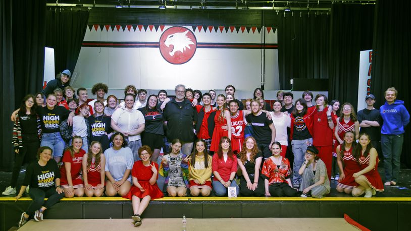 Director Bryan Szekacs and the cast of "High School Musical" Friday, April 19, 2024. This weekend's musical marks the 25th and last time Szekacs will direct the students in a performance. BILL LACKEY/STAFF
