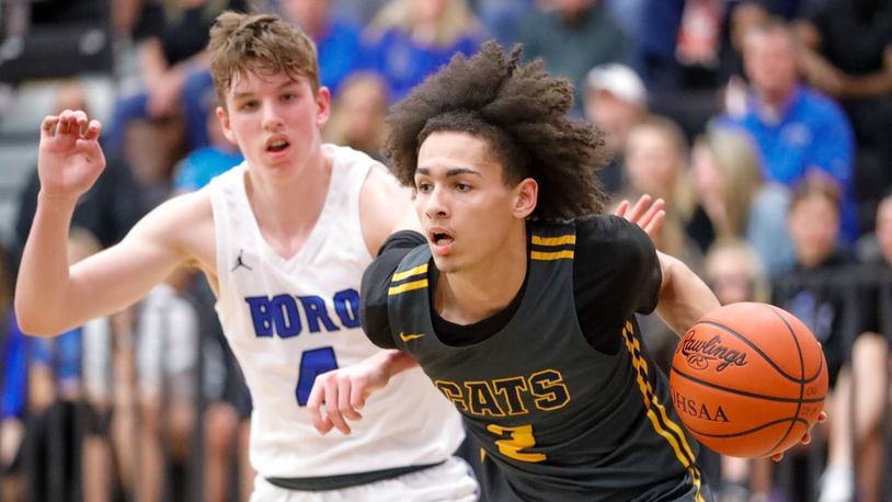 Springfield High School senior Cabrae Byrd drives past Springboro senior Carson Brigger during their Division I district final game on Monday night at Centerville High School. The Panthers won 86-75. Michael Cooper/CONTRIBUTED