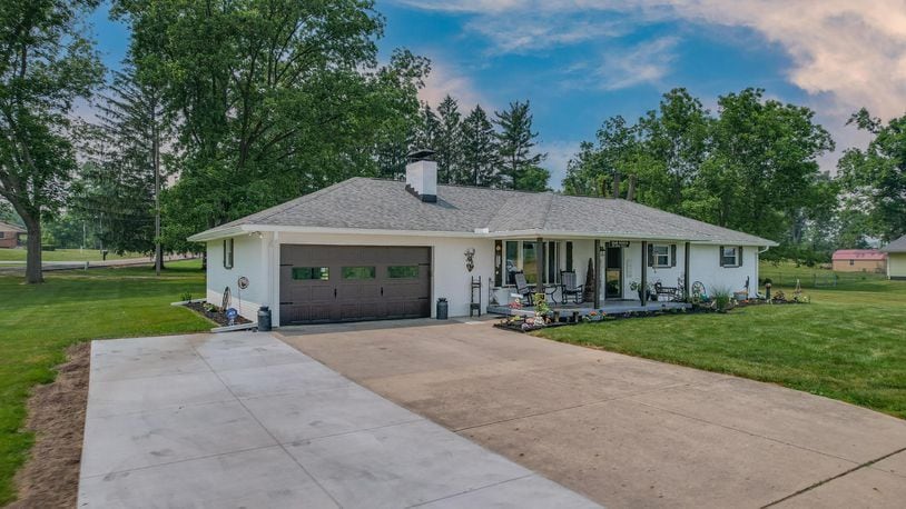 The front of the home has a two-car attached garage with opener and high traffic flooring, an extended driveway with additional parking and a covered front porch. CONTRIBUTED PHOTOS