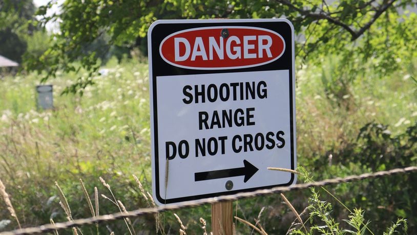 A shooting range warning sign was shot after a man in the 7000 block of Ballentine Pike fired several rounds during his neighbor's garage sale. Many bullets struck neighbor Amy James' storage barn and hay bales. JESSICA OROZCO/STAFF
