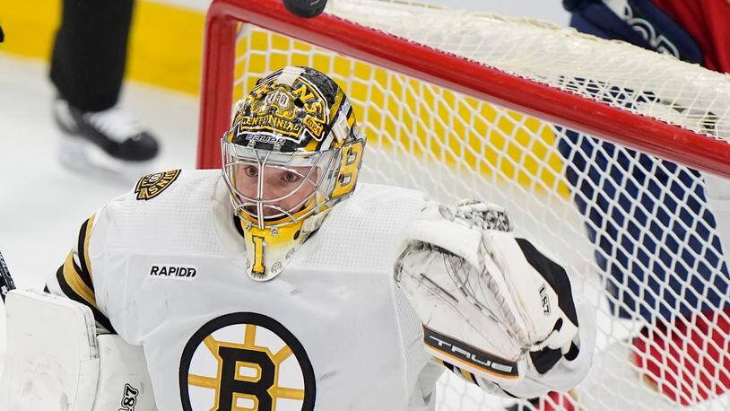 Boston Bruins goaltender Jeremy Swayman (1) deflects a shot during the second period of Game 1 of the second-round series of the Stanley Cup Playoffs against the Florida Panthers, Monday, May 6, 2024, in Sunrise, Fla. (AP Photo/Wilfredo Lee)