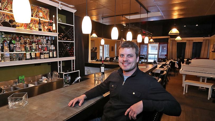 Micah Berner, the owner of Cecil & Lime Cafe at the restaurants new, larger bar. Bill Lackey/Staff