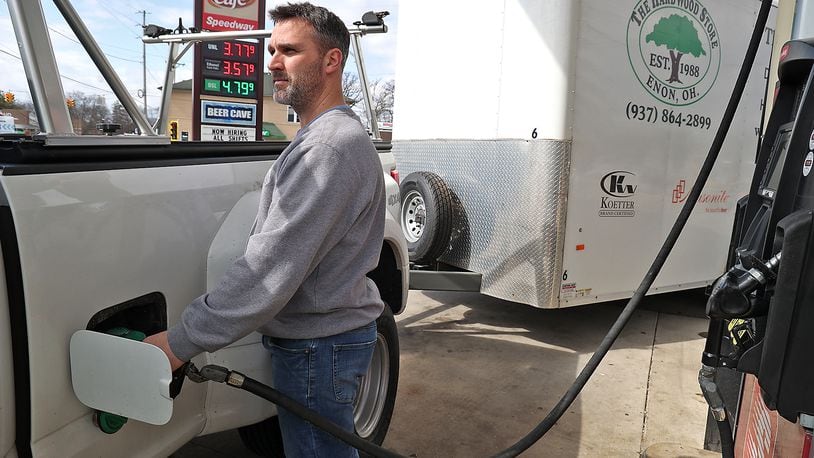Rob Fletcher pumps gas at the Speedway station in Enon Wednesday. Gas prices have slowly been dropping in the area over the last few days. BILL LACKEY/STAFF