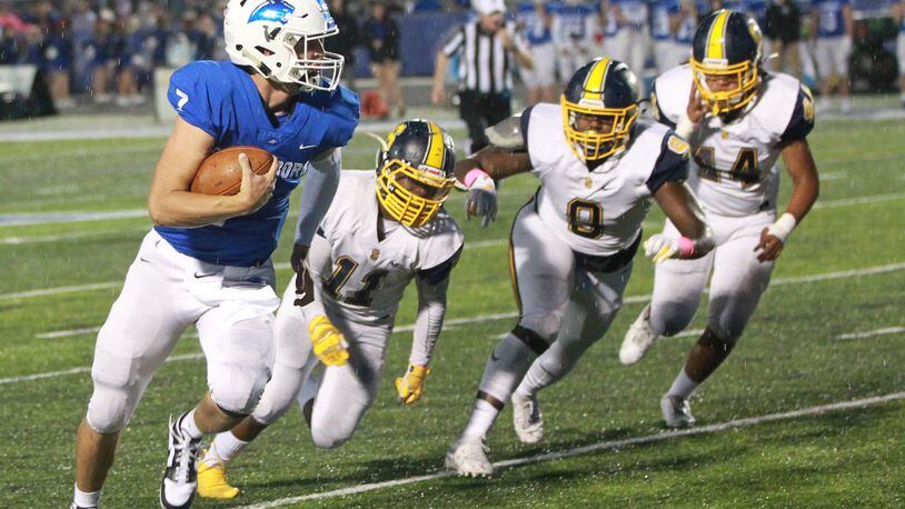 Springboro QB Landon Palmer is chased by Springfield defenders Xzerious Stinnett (11), Bryce Walker (9) and Tayden Harper (44). Springfield defeated host Springboro 23-0 in a Week 7 high school football game on Friday, Oct. 11, 2019. MARC PENDLETON / STAFF
