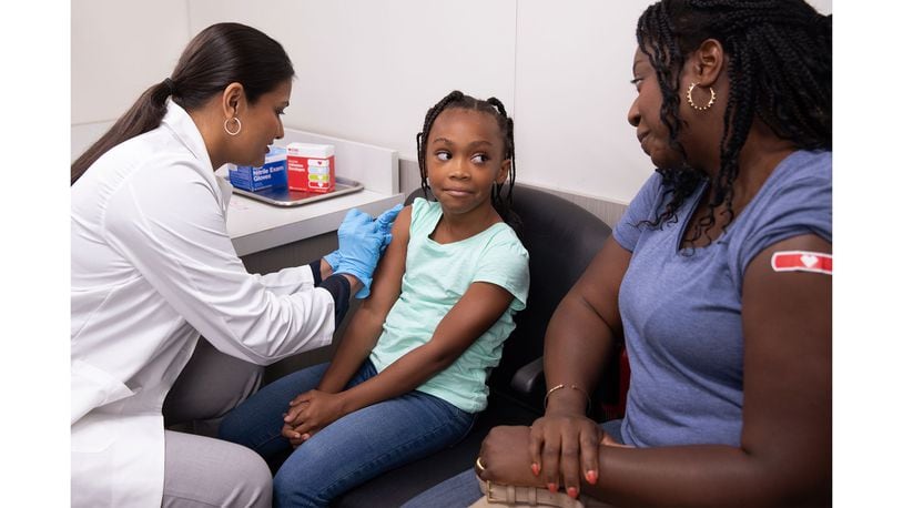 Mother and daughter get flu vaccinations at a CVS Pharmacy. COURTESY OF CVS HEALTH