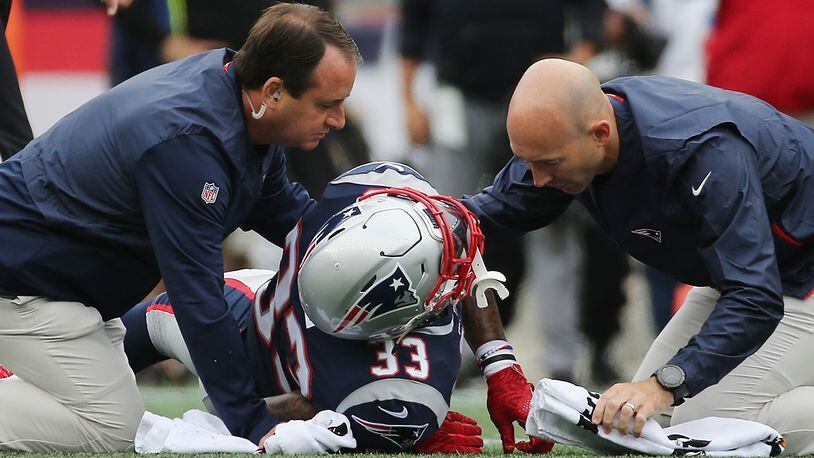 FOXBOROUGH, MA - SEPTEMBER 09:  Jeremy Hill #33 of the New England Patriots is assisted by training staff after suffering an apparent injury during the second half against the Houston Texans at Gillette Stadium on September 9, 2018 in Foxborough, Massachusetts.  (Photo by Jim Rogash/Getty Images)