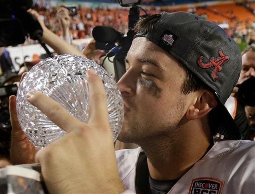 Alabama's AJ McCarron kissed The Coaches' Trophy after the BCS National Championship.