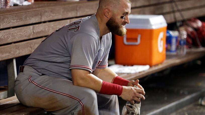 Cincinnati Reds catcher Tucker Barnhart sits in the dugout after the Reds lost to the Miami Marlins 7-4 in a baseball game, Friday, July 28, 2017, in Miami. (AP Photo/Lynne Sladky)