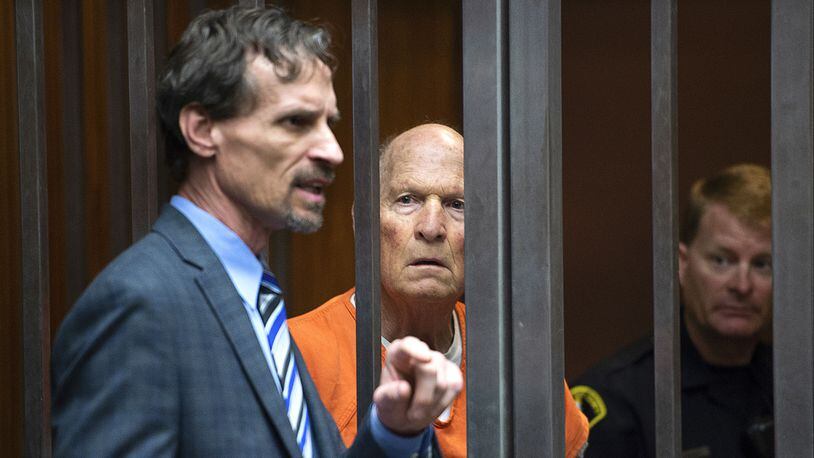 Joseph James DeAngelo Jr., center, listens as his attorney, Joe Cress, speaks in a Sacramento, Calif., courtroom on Tuesday, May 29, 2018, as a judge weighs how much information to release about the arrest of the former police officer accused of being the Golden State Killer. The judge on Friday unsealed the heavily-redacted search warrant and police affidavit that led to DeAngelo's April 24 arrest.