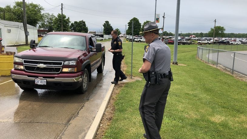 Lt. Brett Bauer of the Springfield Police Department, left, and Lt. Brian Aller of the Ohio State Highway Patrol met motorists as part of the Click It or Ticket safety campaign kickoff at the Clark County Fairgrounds on Friday afternoon. Photo by Brett Turner