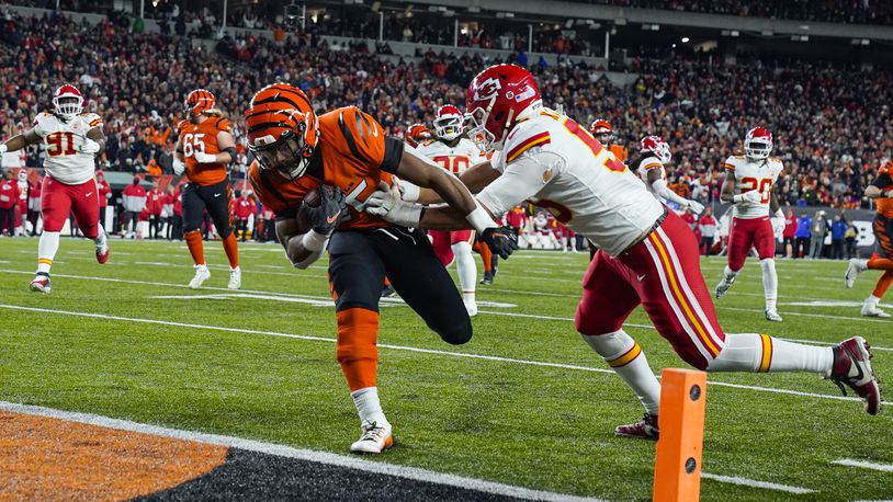 Cincinnati Bengals running back Chris Evans (25) runs in for a touchdown past Kansas City Chiefs defensive end George Karlaftis (56) in the second half of an NFL football game in Cincinnati, Fla., Sunday, Dec. 4, 2022. (AP Photo/Jeff Dean)