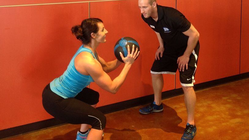 NATALIE BLOMMEL of Centerville gets a personal-training session from Nick Garrison of Centerville at the Urban Active fitness club at The Greene.