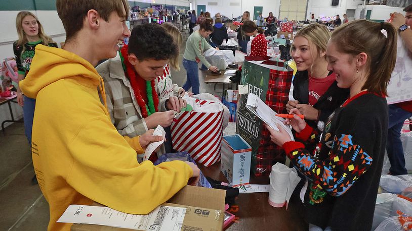 Students from the Global Impact STEM Academy, volunteered Wednesday, Dec. 7, 2022 at the Springfield Salvation Army's "Toy Store" at the Clark County Fairgrounds. GISA students, from left, Daniel Stacy, Jason Purdue, Ansley Turner and Josie Jennings helped gather toys and other items for children of families that requested assistance from the Salvation Army this year for Christmas. The Springfield Salvation Army is supplying gifts for nearly 3000 children this year. BILL LACKEY/STAFF