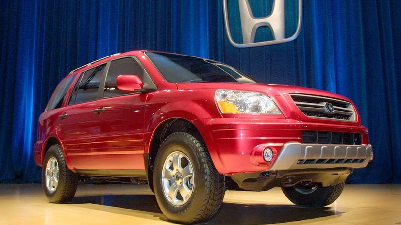 A man attempting to steal a Honda Pilot SUV got a surprise when the woman who owned the vehicle dragged him out of the driver's seat and pinned him to the ground.