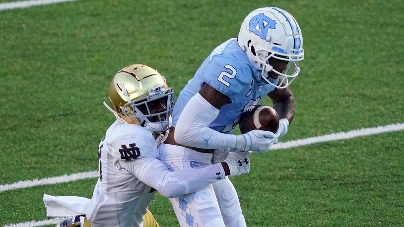 North Carolina wide receiver Dyami Brown (2) catches a pass as Notre Dame cornerback TaRiq Bracy (28) defends during the first half of an NCAA college football game in Chapel Hill, N.C., Friday, Nov. 27, 2020. (AP Photo/Gerry Broome)