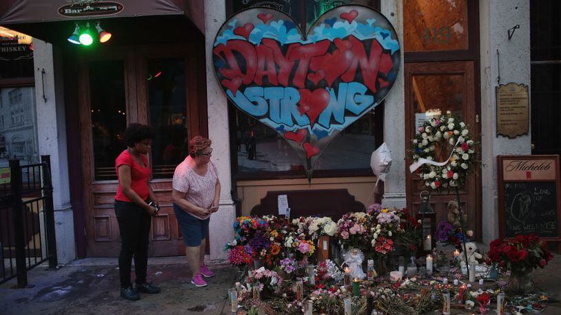 People look over a memorial to those killed in a mass shooting in the Oregon District on August 06, 2019, in Dayton, Ohio. Nine people were killed and another 27 injured when a gunman identified as 24-year-old Connor Betts opened fire.