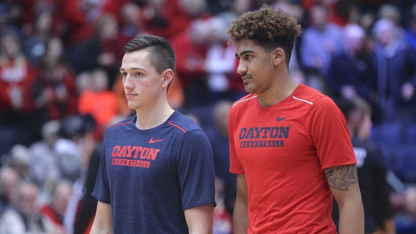 Dayton’s Ryan Mikesell and Obadiah Toppin watch the team warm up before a game against Tennessee Tech on Dec. 6, 2017, at UD Arena. David Jablonski/Staff