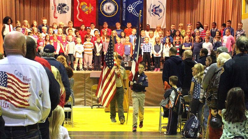 Northridge Elementary and Middle School students (left) Nick Curtis and Matthew Patch retire the colors after the annual Veterans Day program. JEFF GUERINI/STAFF
