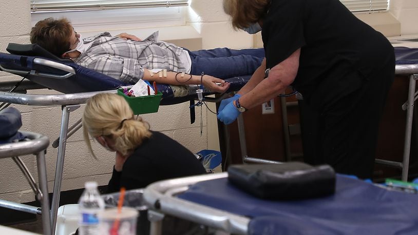 People donate blood during a blood drive in December at the Father Paul Vieson Center in New Carlisle. Community Blood Center has several blood drives planning in Clark County in January. BILL LACKEY/STAFF