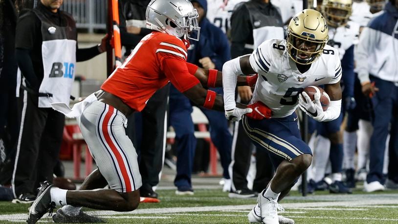 Akron receiver Konata Mumpfield, right, cuts upfield after a catch as Ohio State defensive back Sevyn Banks defends during the first half of an NCAA college football game Saturday, Sept. 25, 2021, in Columbus, Ohio. (AP Photo/Jay LaPrete)