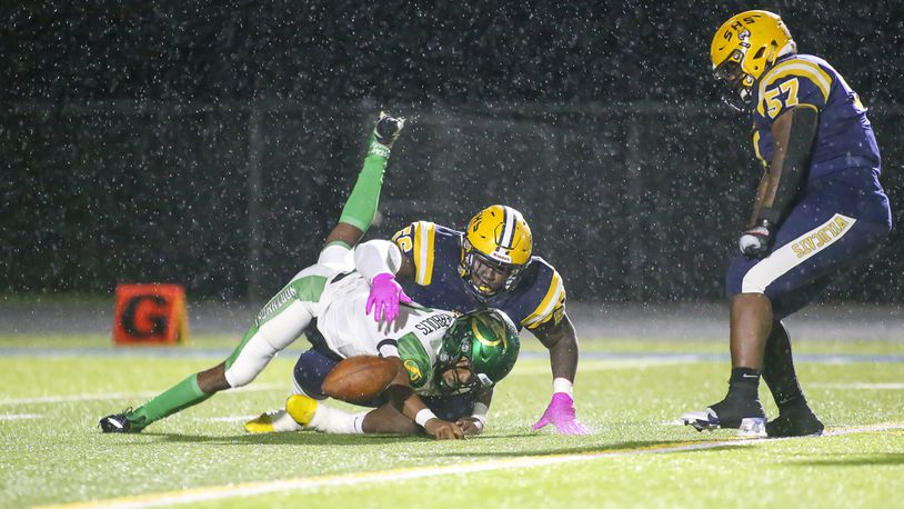 Springfield High School senior Tywan January sacks Northmont quarterback Cahke' Cortner while senior teammate Jokell Brown celebrates during their game on Friday, Oct. 29 in Springfield. Michael Cooper/CONTRIBUTED
