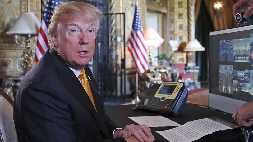President Donald Trump speaks to the media before speaking with members of the armed forces via video conference at his private club, Mar-a-Lago, on Thanksgiving, Thursday, Nov. 23, 2017, in Palm Beach, Fla. (AP Photo/Alex Brandon)