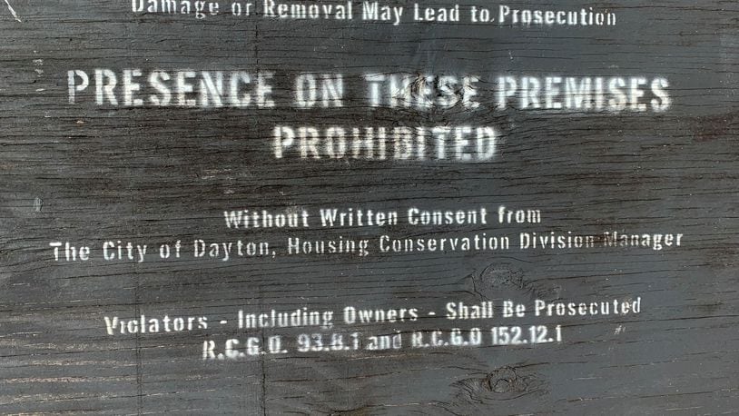 A sign over the garage of a home on Wheatley Avenue says presence is prohibited. The owner of the home received $11,500 last year through a rental assistance program funded with federal CARES Act money. The property did not have water last year.